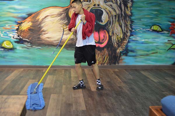 Teen boy doing morning chores