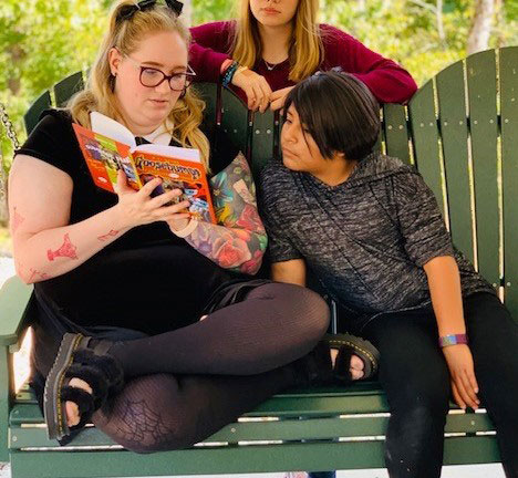 Preteen girl reading with a counselor