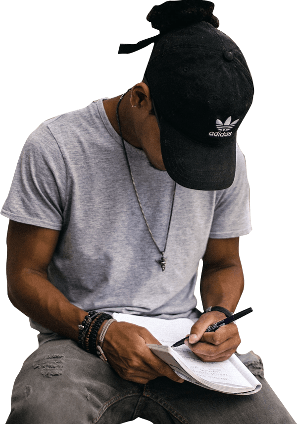 Teen boy writing in a journal
